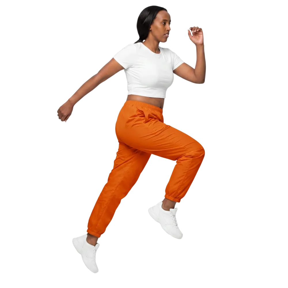 Unisex Trainingshose von BUYATHOME24 in Orange, aus Polyester mit Reißverschlusstaschen, bequem und sportlich für Damen und Herren.